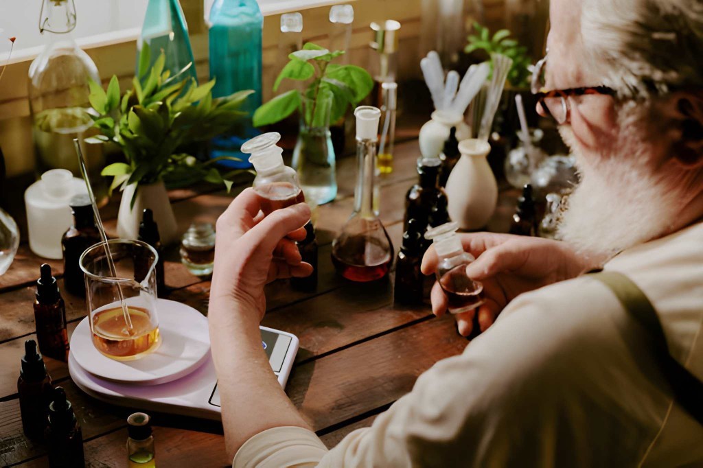 A perfumer blending a fragrance formula at the workbench